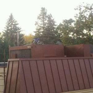A bike on an AC unit on a roof. Wtf?