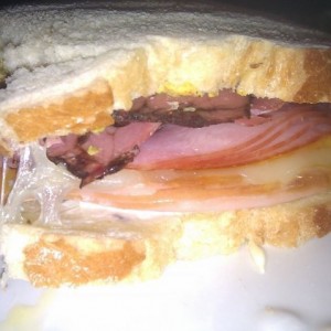 Hot ham, turkey, pastrami, melted cheddar, and provolone cheese all set ato