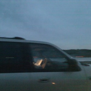 Fucktard reading hardcover book on freeway. Wtf.
