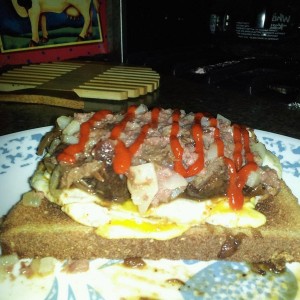 Egg, pot roast, corned beef, saracha and cayenne pepper ontop of whole whea