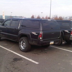 Dirty truck with shiny new wheels & tires parked next to my Off Road tw