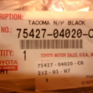 Tacoma Name/Plate Black. Part number.