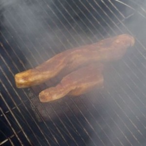Slab bacon basting a boneless turkey breast. Pork tenderloin to go on later