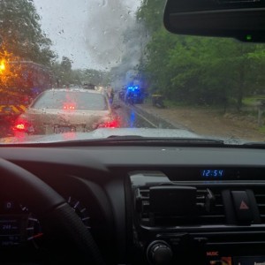 Watching a Jeep burn while the rain cleans the pollen off of my 4Runner. (No one was in the Jeep)