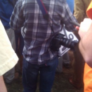 How to spot a hipster. Big ass camera, plad, skinny jeans, sign that says &