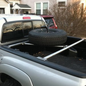 Tire carrier/bed bars
