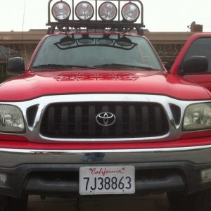 red tacoma with roof rake hids hella 5000s