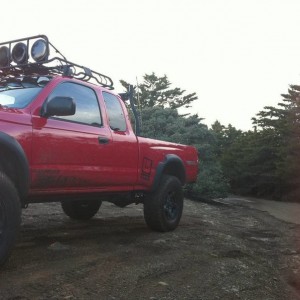 red tacoma with roof rake hids hella 5000s