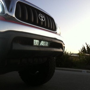 red tacoma with roof rake hids hella 5000s