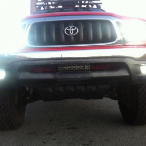 red tacoma with roof rake hids hella 5000s