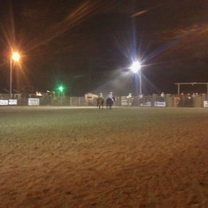 At the rodeo. Little girl on the left horse is probably 10 and handling tha