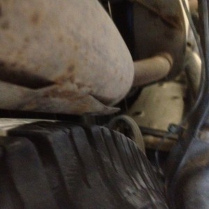 285 full size spare. About 3/8 of an inch maybe 1/2 between it and the exha