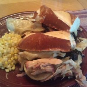 Smoked pulled pork with pierogis on a pretzel bun! FTW!