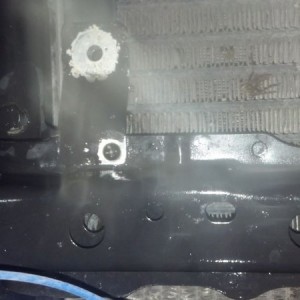 Ripped out radiator mounting bolt. Otherside, the side with zipties held.