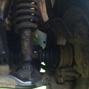 Front suspension, see something wrong with the bottom coil spring mount?