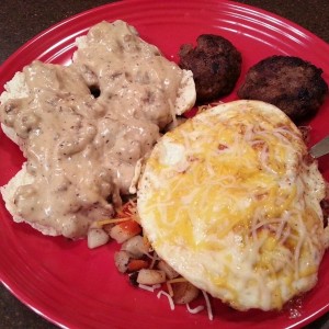 Homemade biscuits and sausage gravy, potatoes O'Brien with two eggs ov