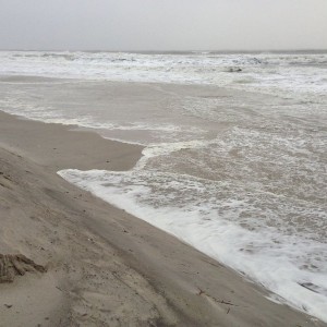 Water up to makeshift dunes and still an hour to high tide Dam