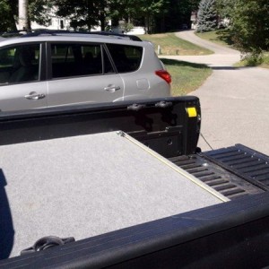 2013 DCLB, carpeted bed deck with storage bins.