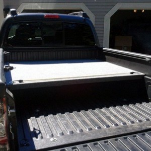 2013 DCLB, carpeted bed deck with storage bins.