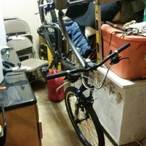 Bike rack using a pipe clamp and 4x4 post with hole drilled in it for seat 