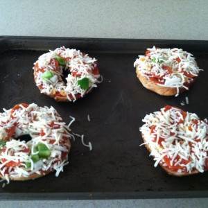 Pizza bagels with green peppers, onions, pepperoni and habenero pepper.