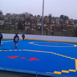 Son playing deck hockey. But its pouring.