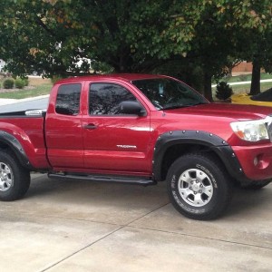 Red tacoma with black fender flares