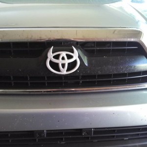 Toyota devil horns emblem mounted on factory 4runner grill