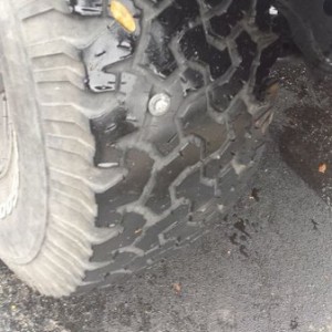At least its on the tire with the least tread.