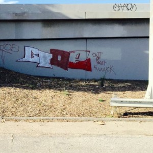 Graffiti on 5 Fwy southbound at Main St. exit in LA. Tagger has a sense of 