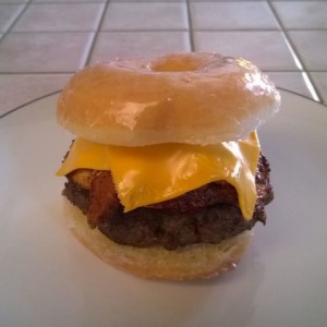 Yes, that is a fried egg on top of a sausage patty covered in bacon and pro