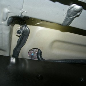 Hole under back of driver seat