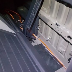 behind driver-passenger back seat