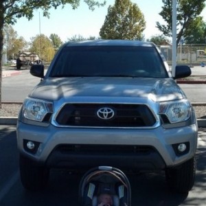 A boy and his truck impatiently wait for his chauffeur to quit dicking around.