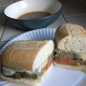 Sausage stuffed sausage roll sandwich. Side of gravy for the dipping.