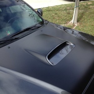 Had the center portion of the hood wrapped in satin black. It does cut the glare off the skewp.